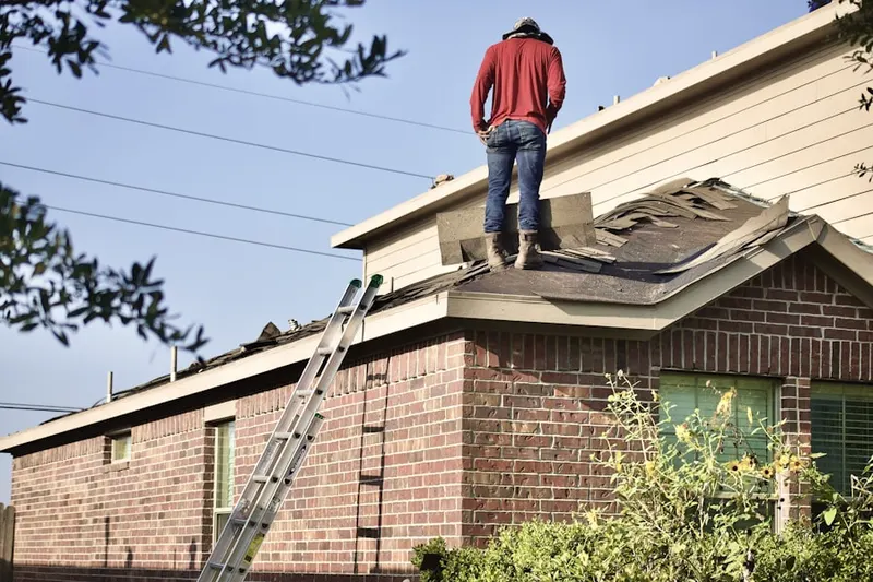 Professional roofer working on a residential roof in Topeka East